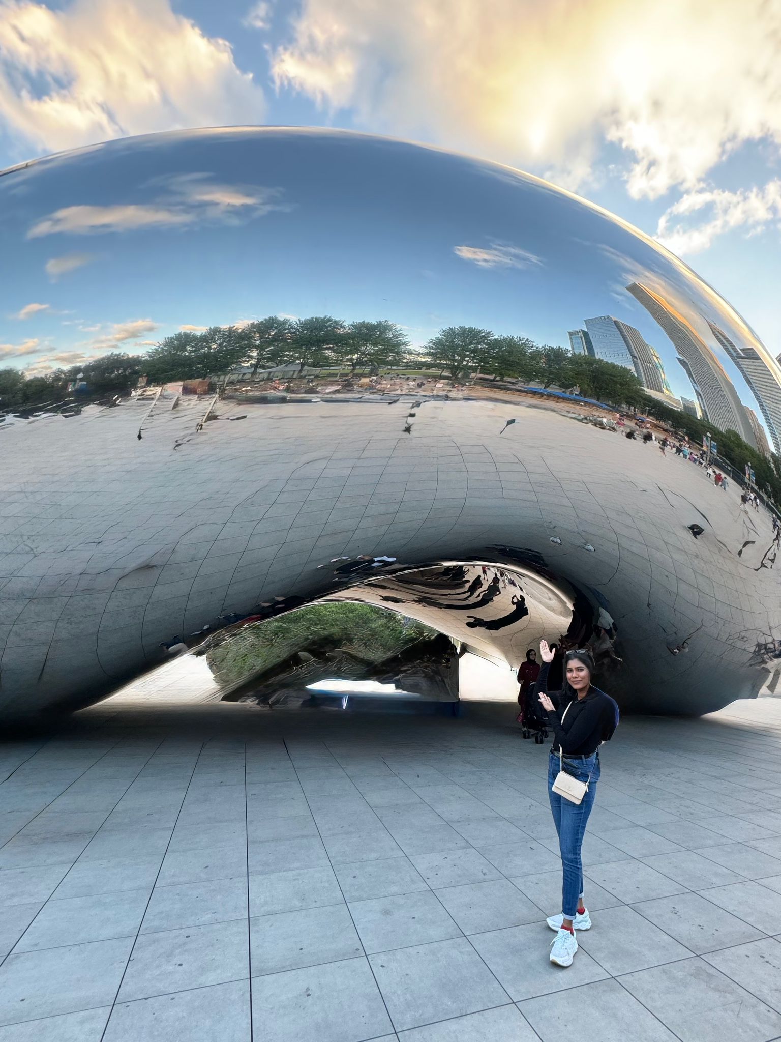 Mehak waving in front of the Cloud Gate sculpture in Chicago