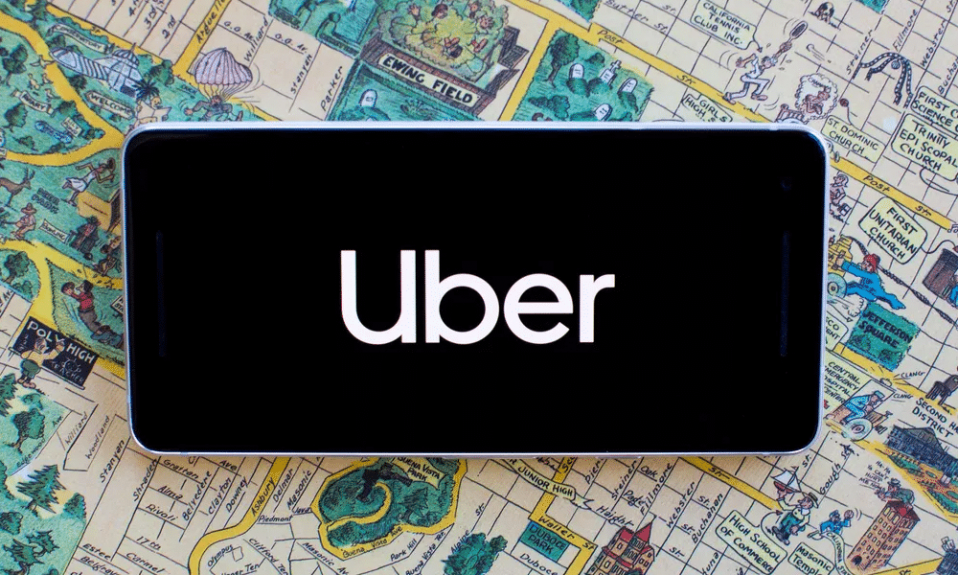 Uber app on a phone laid over a vintage city map